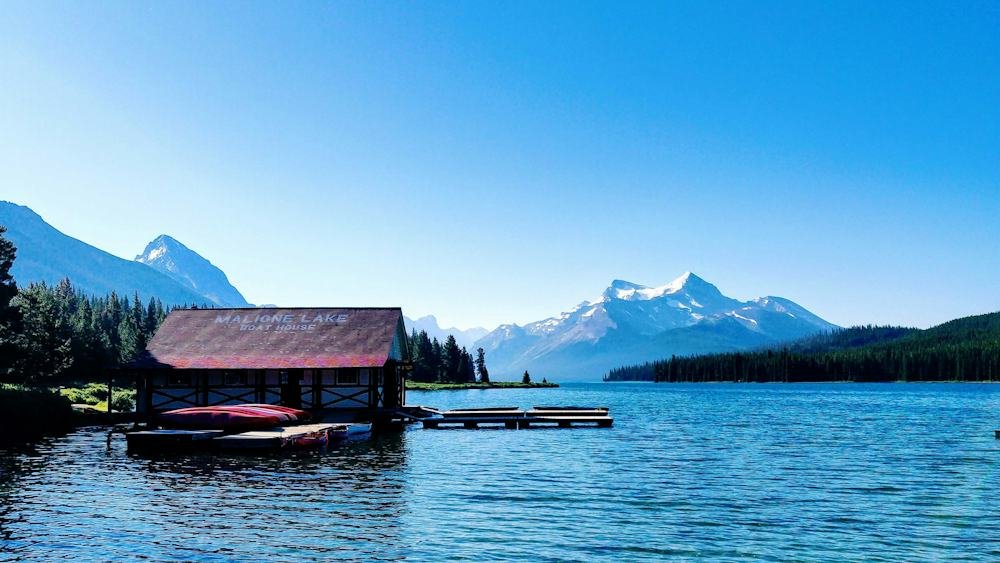 Cozy lakefront cabin surrounded by mountains, a peaceful romantic retreat for couples