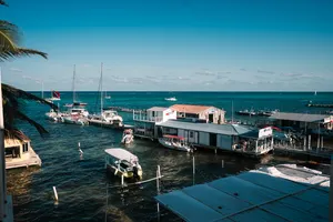 Marina with sailboats and clear blue waters in Belize during shoulder season