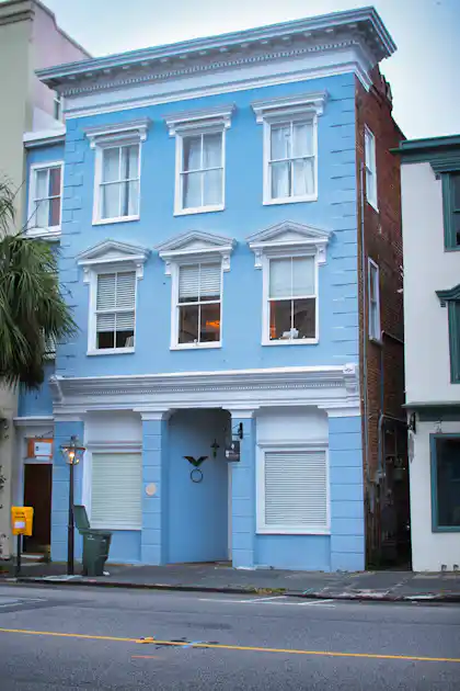 Light blue historic building with white trim in Charleston during fall
